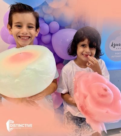 two kids holding different shaped cotton candy