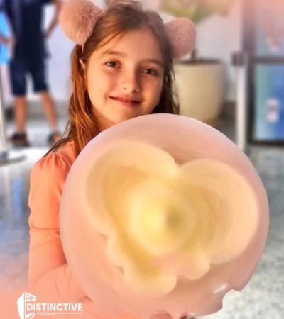 a girl holding heart shaped cotton candy